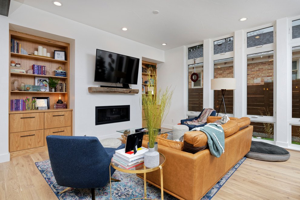 A bright Renovar living room painted crisp white, with white window trim and a wood built-in